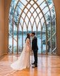 Bride Wearing Simple Long Sleeve Wedding Dress Called Bethany By Rebecca Ingram Kissing Groom