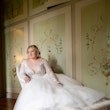 Bride Laying On Chaise Lounge Wearing Bridal Dress Called Mallory Dawn by Maggie Sottero
