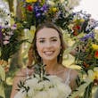 Bride wearing Charlotte by Rebecca Ingram surrounded by bridesmaid bouquets