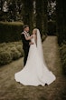 Bride wearing Paxton by Maggie Sottero embracing her husband