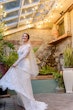 Bride Wearing Boho Sleeved Wedding Dress Called Drita By Maggie Sottero Twirling Her Dress