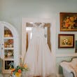 Lace Ballgown Wedding Dress Called Olivia by Rebecca Ingram Hanging on a Doorframe