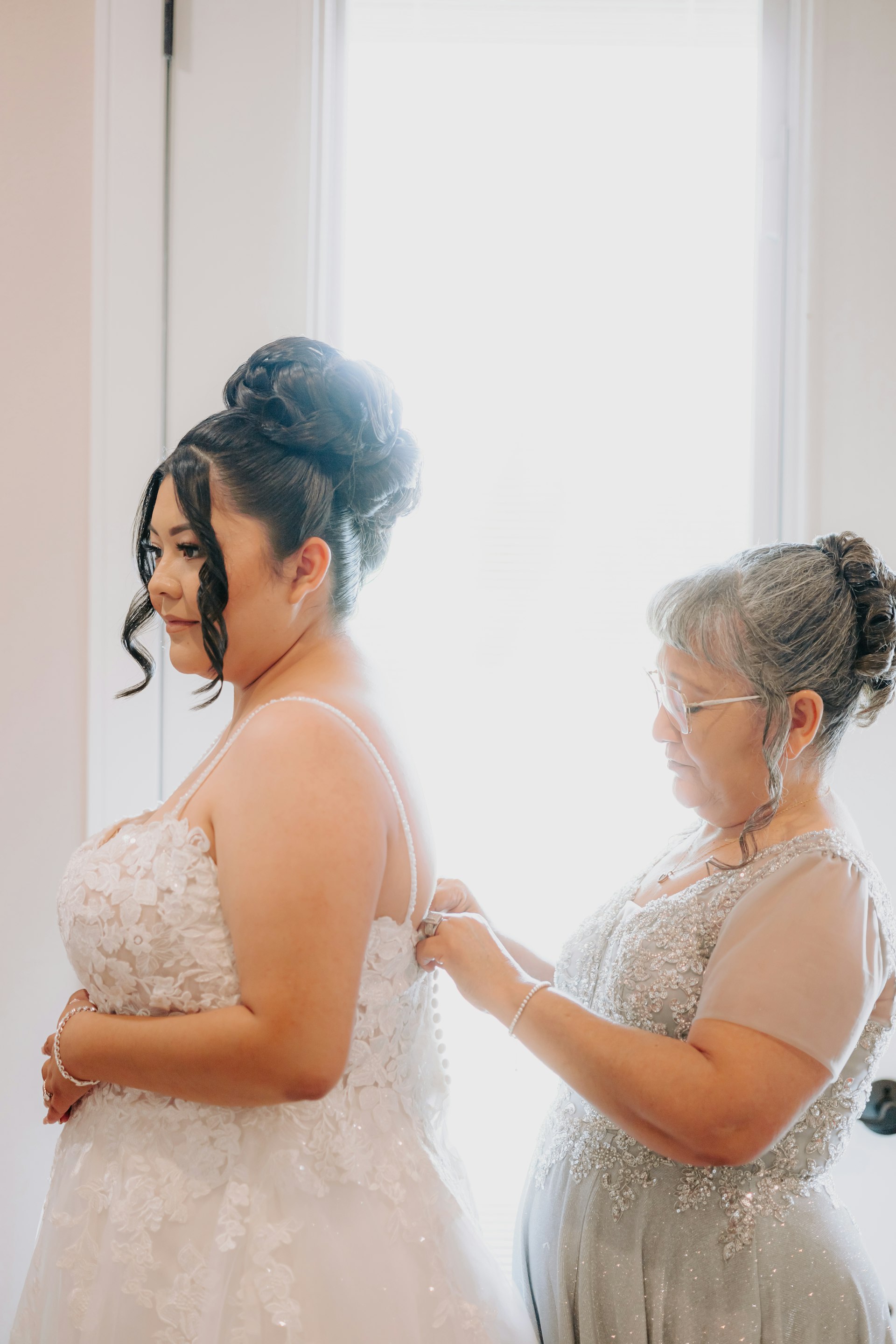 Bride wearing Stevie by Maggie Sottero being buttoned up