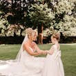 Bride wearing Tuscany Royale by Maggie Sottero holding hands with a little girl
