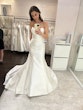 Bride Trying On A White Wedding Dress Named Missy By Rebecca Ingram