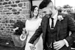 Bride Wearing Simple Keyhole Back Wedding Dress Called Aston By Sottero and Midgley Holding Hands With Groom