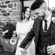 Bride Wearing Simple Keyhole Back Wedding Dress Called Aston By Sottero and Midgley Holding Hands With Groom