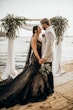 Bride Wearing Black Fit And Flare Wedding Dress Called Zander Lane By Sottero And Midgley Holding Hands With Groom