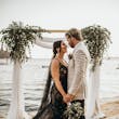 Bride Wearing Black Fit And Flare Wedding Dress Called Zander Lane By Sottero And Midgley Holding Hands With Groom