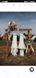 Two Maggie Sottero Wedding Dresses Hanging From A Decorated Post