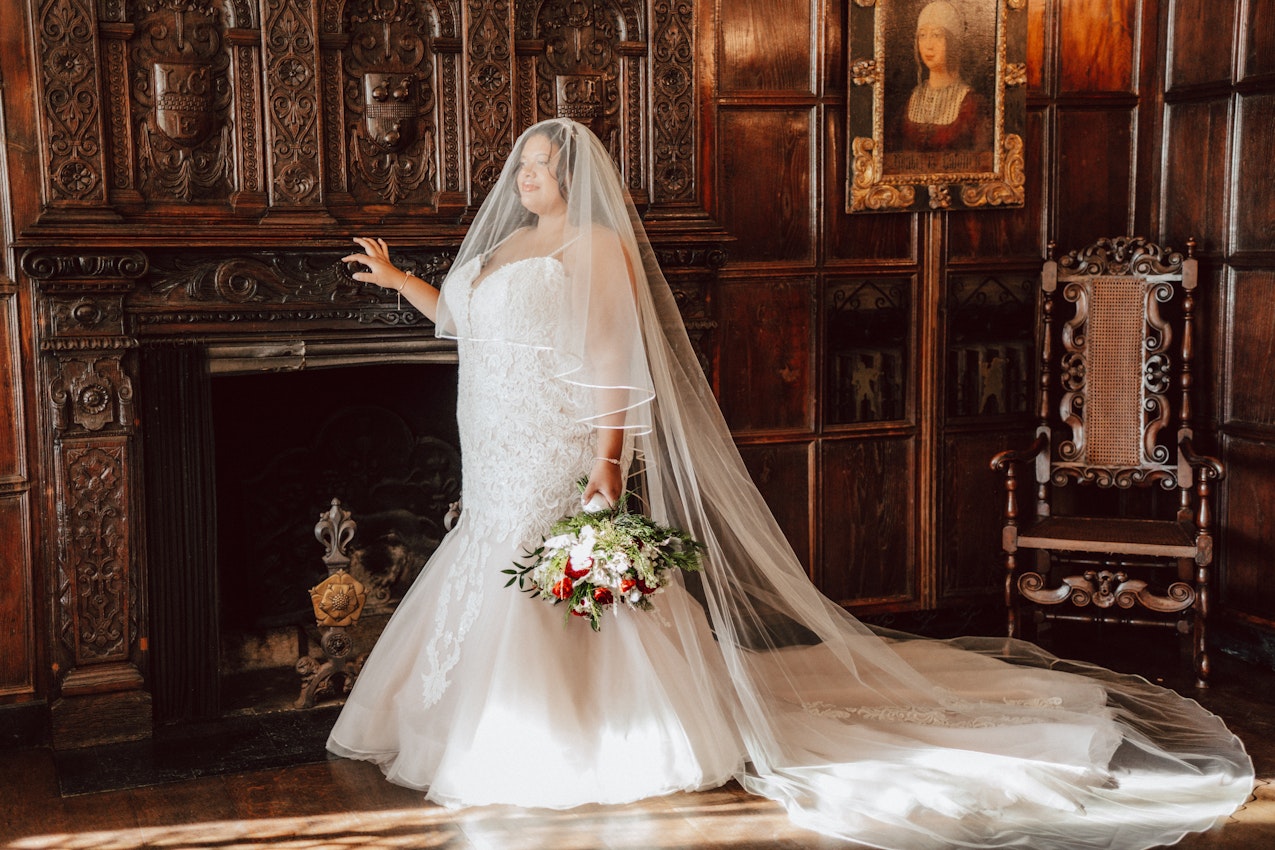 Bride in Rustic Room Wearing Veil and Wedding Dress Called Alistaire Lynette by Maggie Sottero