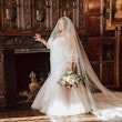 Bride in Rustic Room Wearing Veil and Wedding Dress Called Alistaire Lynette by Maggie Sottero