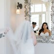 Bride wearing Hattie Lynette wedding dress by Rebecca Ingram looking in the mirror