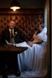 Bride Wearing Chiffon Lace Wedding Dress Called June By Maggie Sottero Sitting At A Booth With Groom