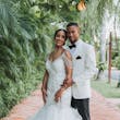 Bride with groom wearing glamorous mermaid wedding dress