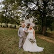 Groom and Bride at an Outdoor Wedding Wearing Lace Ballgown Wedding Dress Called Olivia by Rebecca Ingram