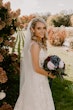 Bride Wearing Square Neck Long Sleeve Floral Wedding Dress Called Sawyer By Sottero And Midgley Holding Flower Bouquet Outside