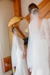 Bride Wearing Boho Sleeved Wedding Dress Called Drita By Maggie Sottero Looking In A Mirror