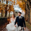 Bride wearing Lettie wedding dress by Rebecca Ingram walking with her husband