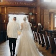Bride with groom wearing halter ballgown wedding dress.