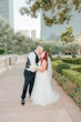 Groom and Bride Kissing at a Las Vegas Wedding Wearing Lace Ballgown Called Ellen by Rebecca Ingram