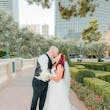 Groom and Bride Kissing at a Las Vegas Wedding Wearing Lace Ballgown Called Ellen by Rebecca Ingram