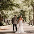 Bride wearing Tuscany Royale by Maggie Sottero walking with her husband