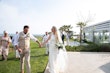 Bride wearing Davis Leigh wedding dress by Sottero and Midgley holding hands with her husband