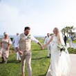 Bride wearing Davis Leigh wedding dress by Sottero and Midgley holding hands with her husband