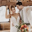 Bride wearing Sydney by Maggie Sottero riding the bus with her husband