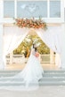 Bride wearing Casey by Maggie Sottero in front of her venue