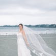 Bride Wearing Boho Sheath Wedding Dress Called Marisol By Rebecca Ingram On The Beach