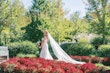 Bride Wearing Sexy Lace Wedding Dress Called Lennon By Maggie Sottero Walking Through A Garden