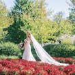 Bride Wearing Sexy Lace Wedding Dress Called Lennon By Maggie Sottero Walking Through A Garden