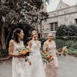Bride wearing Sydney by Maggie Sottero walking with her bridesmaids