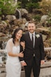 Bride wearing Clover by Rebecca Ingram with her husband