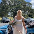 Bride wearing Mindel wedding dress by Maggie Sottero getting out of a car
