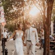 Bride wearing Sydney by Maggie Sottero walking with her husband