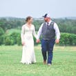 Bride wearing Drita wedding dress by Maggie Sottero holding hands with her husband