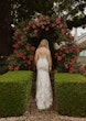 Bride wearing Greenley wedding dress by Maggie Sottero walking through a garden