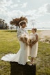 Bride Wearing Crepe Wedding Dress Called Dionne By Rebecca Ingram With Her Daugher Both Holding Bouquets