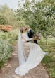 Bride wearing Bethany wedding dress by Rebecca Ingram kissing her husband