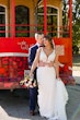 Bride wearing Hamilton wedding dress by Sottero and Midgley in front of a bus