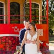 Bride wearing Hamilton wedding dress by Sottero and Midgley in front of a bus