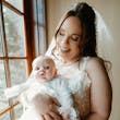 Bride Wearing Lace Wedding Dress Called Ladonna By Maggie Sottero Holding Baby