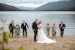 Bride Wearing Lace Aline Wedding Dress Called Harlem By Maggie Sottero With Wedding Party Running Behind Them