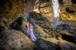 Bride wearing Tuscany Lynette by Maggie Sottero with her husband under a waterfall