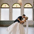 Bride wearing Zinaida by Maggie Sottero kissing her husband