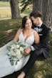 Bride wearing Tuscany Royale by Maggie Sottero sitting with her husband