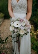 Bride wearing Lorraine by Rebecca Ingram and her bouquet